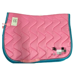 Pink horse saddle pad with a quilted design and teal trim.
