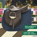 Brown horse saddle pad with quilted design and a saddle resting on it