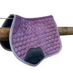 Purple hexagonal quilted horse saddle pad hanging on a wooden rail